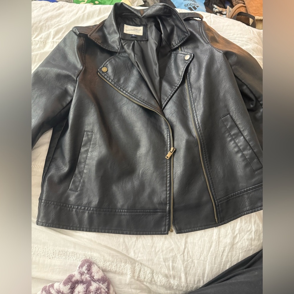 Black leather jacket with gold hardware